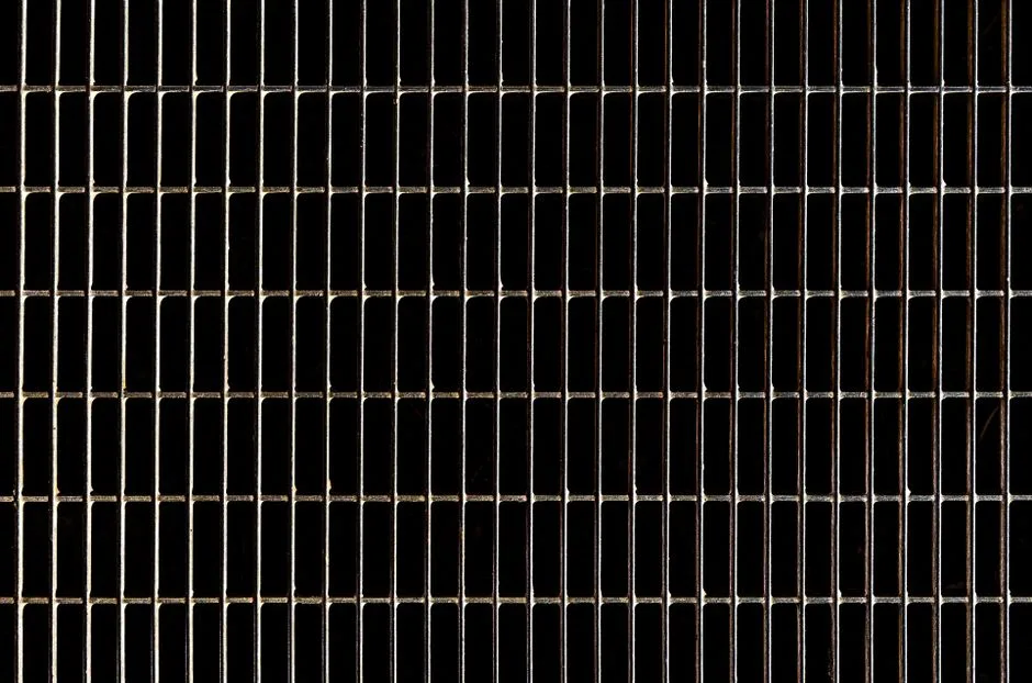 Close-up of grid-like stainless steel texture with a geometric pattern — similar to baffle filter construction